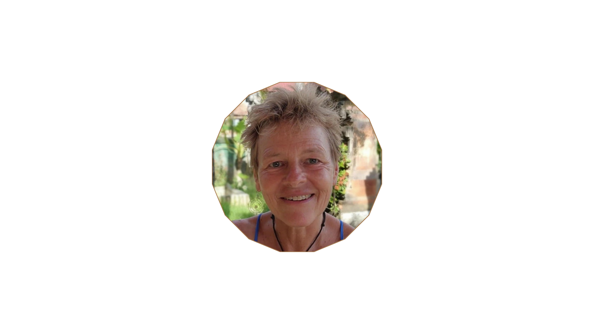 BeAta, smiling, in a sunlit garden